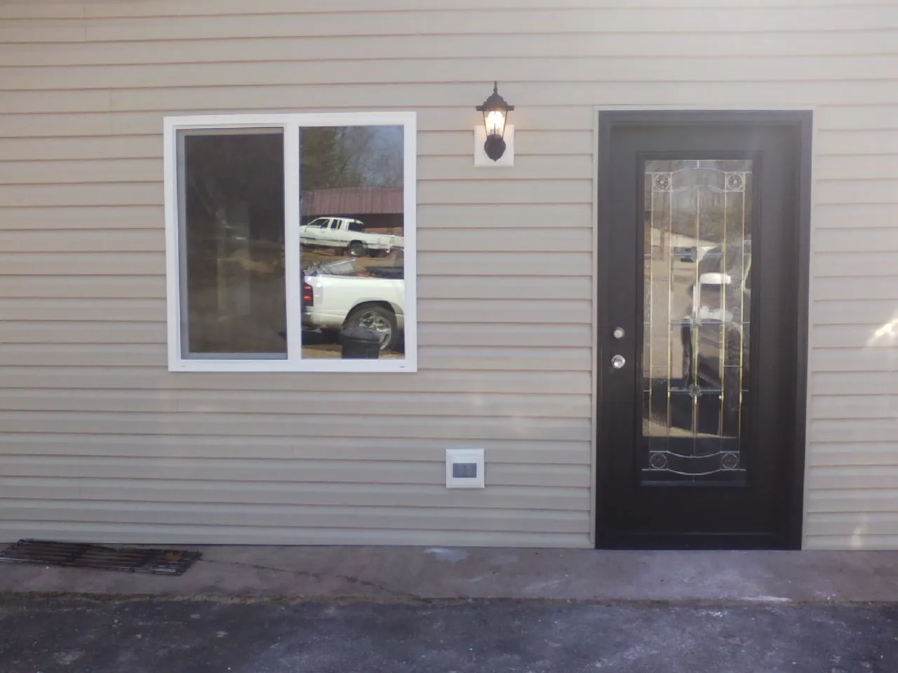 New siding, window and entry door on the side of an addition in Conway